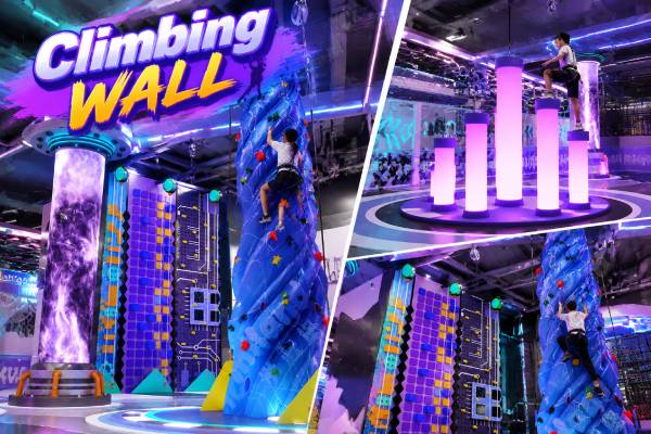 Indoor climbing wall with challenge elements designed for active play experiences in a commercial playground